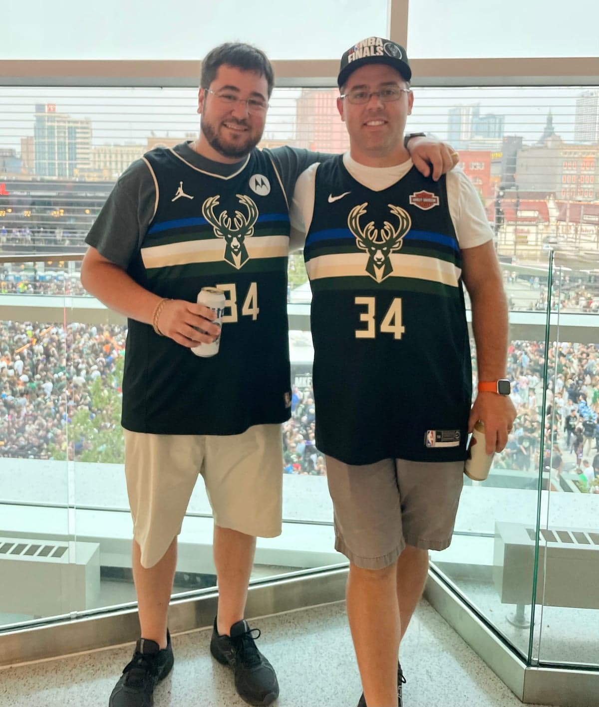 Nick and his brother together at a Milwaukee Bucks game